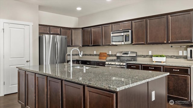 kitchen featuring stainless steel appliances, dark brown cabinets, and sink