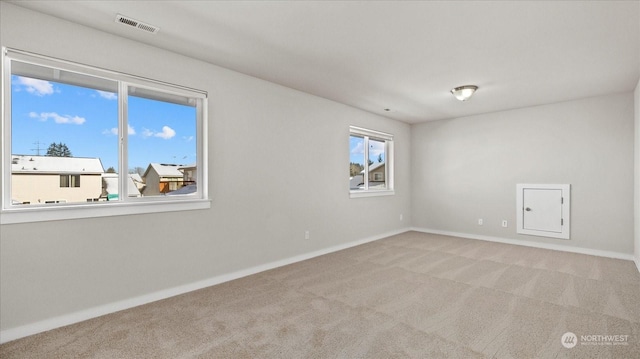 unfurnished room featuring light carpet