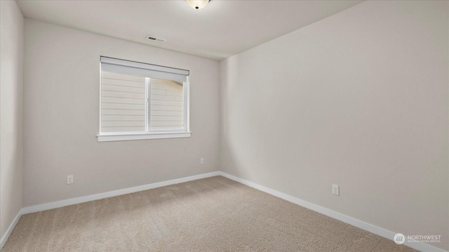 unfurnished room featuring carpet flooring