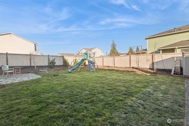 view of yard with a patio area and a playground