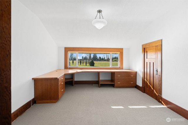 carpeted office space with lofted ceiling