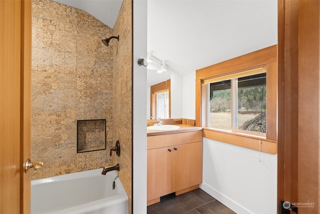 bathroom with vanity, tile patterned floors, tiled shower / bath, and lofted ceiling