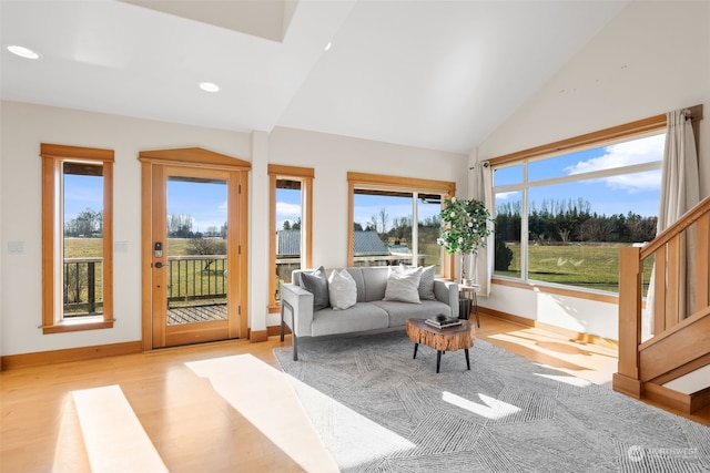 sunroom / solarium with lofted ceiling and a healthy amount of sunlight