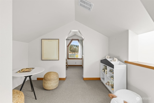 interior space with vaulted ceiling and carpet