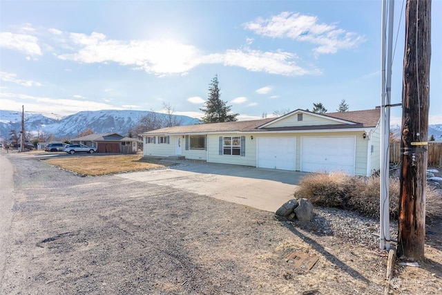 single story home featuring a mountain view and a garage