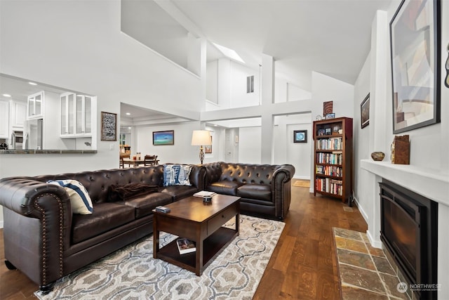 living room featuring dark hardwood / wood-style flooring, high vaulted ceiling, and beverage cooler