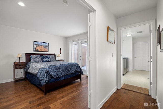 bedroom featuring washer / clothes dryer, access to outside, and dark hardwood / wood-style floors