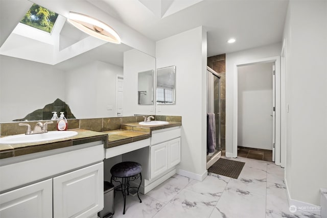 bathroom with vanity, an enclosed shower, and a skylight