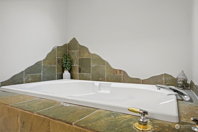 bathroom featuring tiled tub