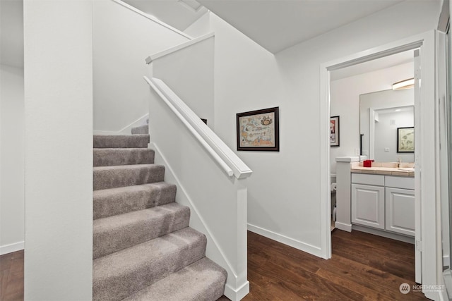 staircase with indoor bar and hardwood / wood-style floors