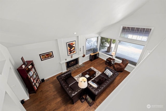 living room featuring dark hardwood / wood-style flooring and lofted ceiling