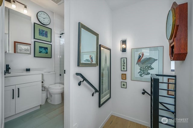 bathroom with vanity, hardwood / wood-style floors, and toilet