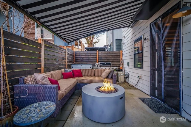 view of patio featuring an outdoor living space with a fire pit