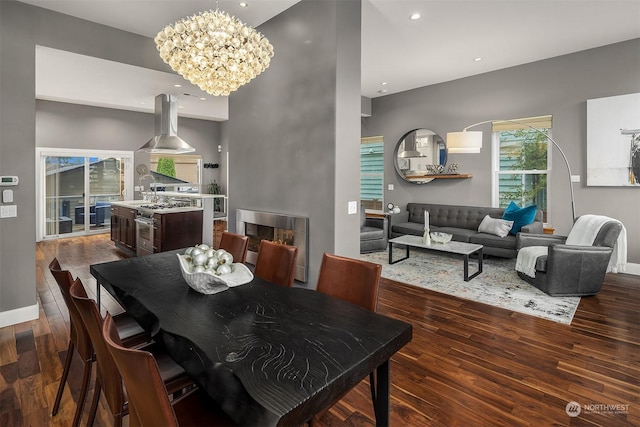 dining room with dark wood-type flooring and a notable chandelier