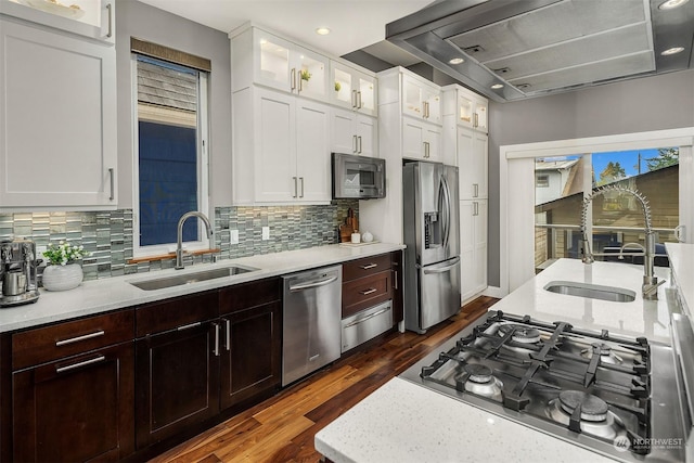 kitchen with stainless steel appliances, sink, and white cabinets