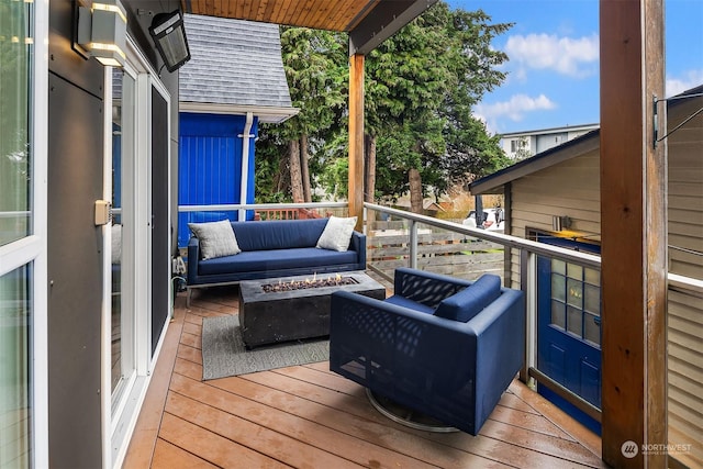 wooden terrace featuring a fire pit