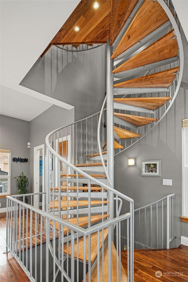 stairs featuring hardwood / wood-style floors