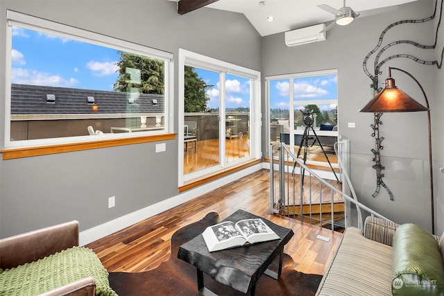 sunroom featuring ceiling fan, vaulted ceiling, and an AC wall unit