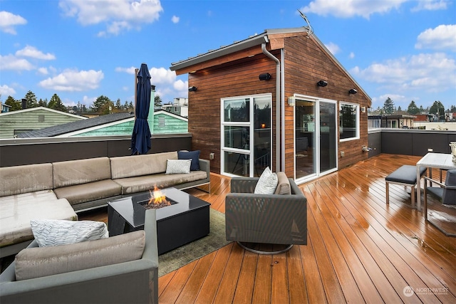 wooden deck with an outdoor living space with a fire pit