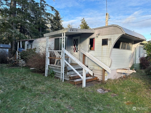 rear view of house with a lawn