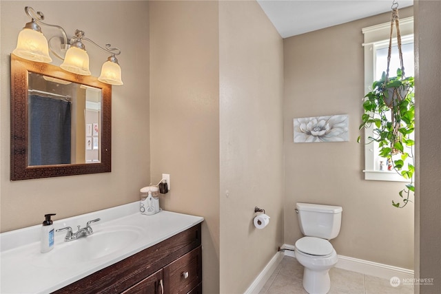 bathroom featuring vanity, toilet, and tile patterned flooring