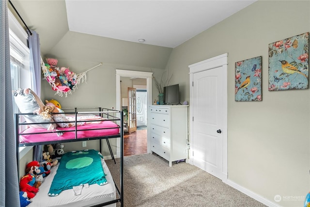 carpeted bedroom with vaulted ceiling