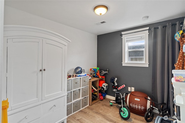 recreation room with light hardwood / wood-style floors