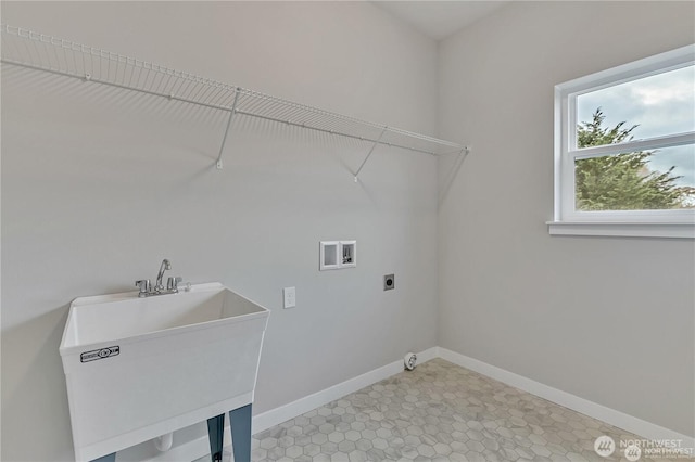 laundry area featuring laundry area, baseboards, hookup for an electric dryer, washer hookup, and a sink