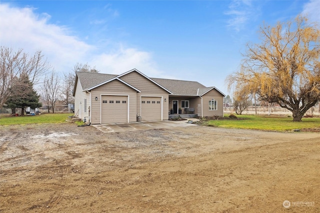 view of front of property with a garage and a front yard