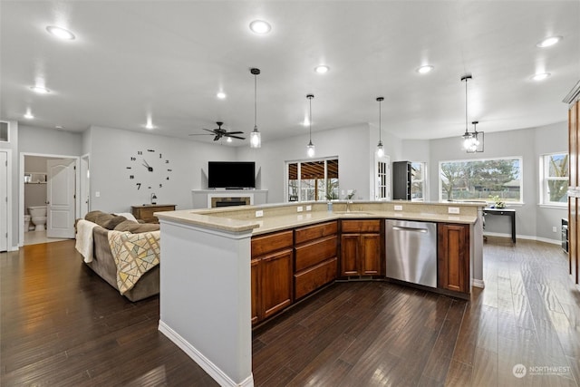 kitchen with decorative light fixtures, stainless steel dishwasher, dark hardwood / wood-style floors, and a spacious island