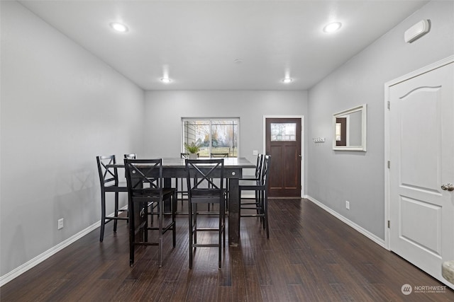 dining space with dark wood-type flooring