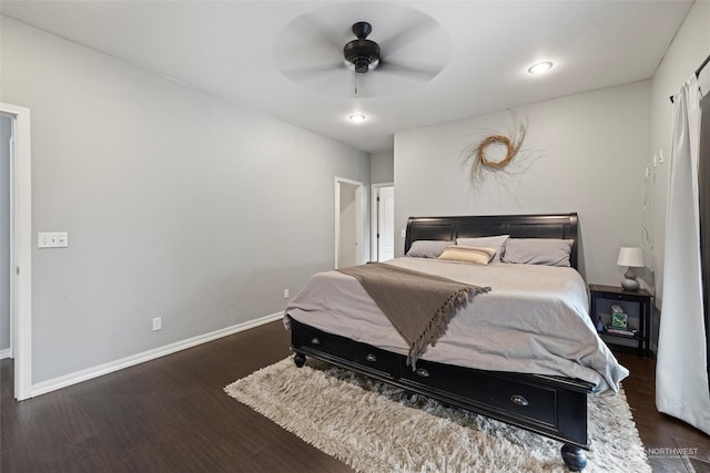 bedroom with dark hardwood / wood-style floors and ceiling fan