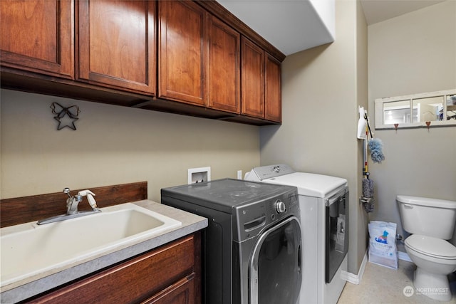 clothes washing area with sink and washer and clothes dryer