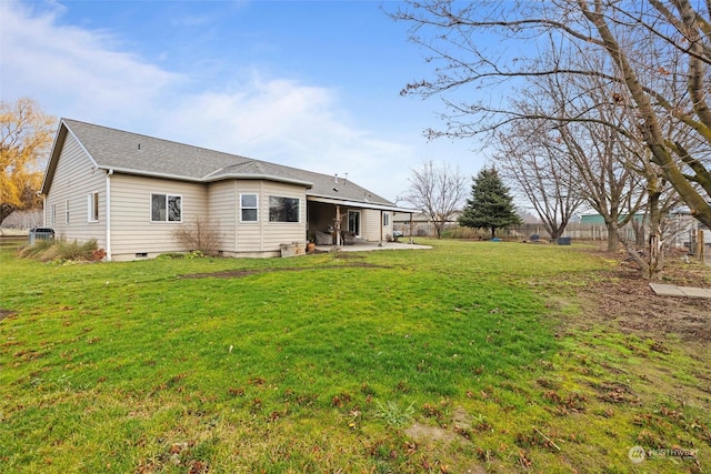 back of property featuring a patio area and a lawn