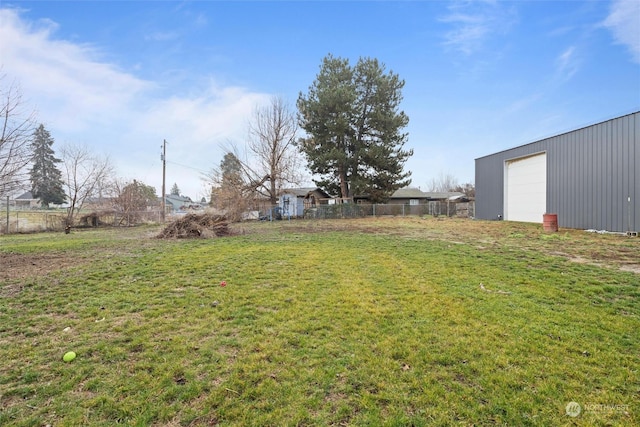 view of yard with a garage and an outdoor structure