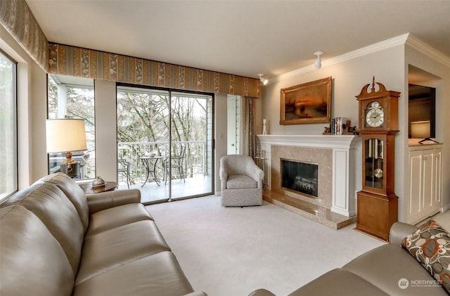 carpeted living room with crown molding and a high end fireplace