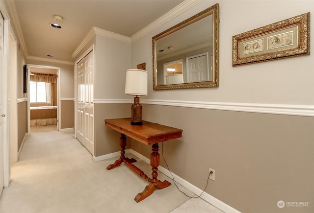 corridor with crown molding and light colored carpet