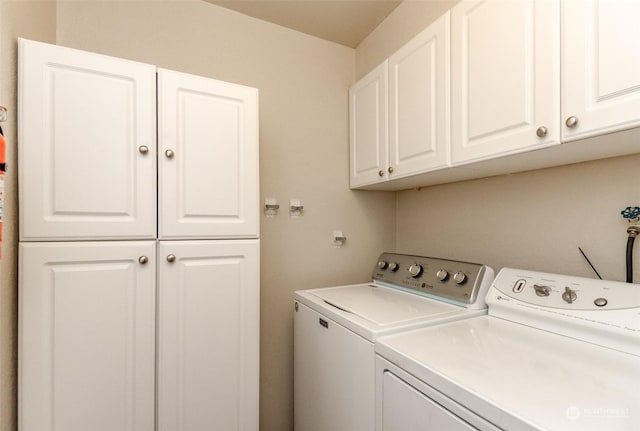 washroom with cabinets and separate washer and dryer