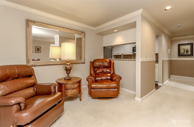 sitting room with crown molding and light carpet