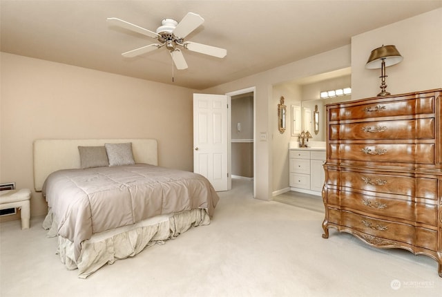 carpeted bedroom featuring ensuite bathroom and ceiling fan