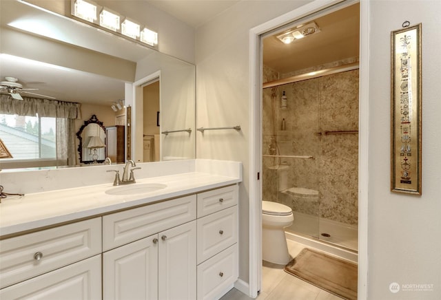 bathroom featuring an enclosed shower, ceiling fan, vanity, and toilet