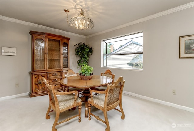 dining room with ornamental molding, light colored carpet, and a chandelier