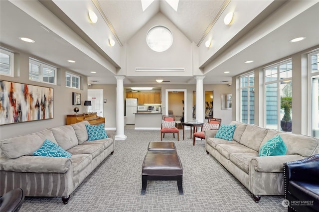 living room with decorative columns, plenty of natural light, and carpet flooring