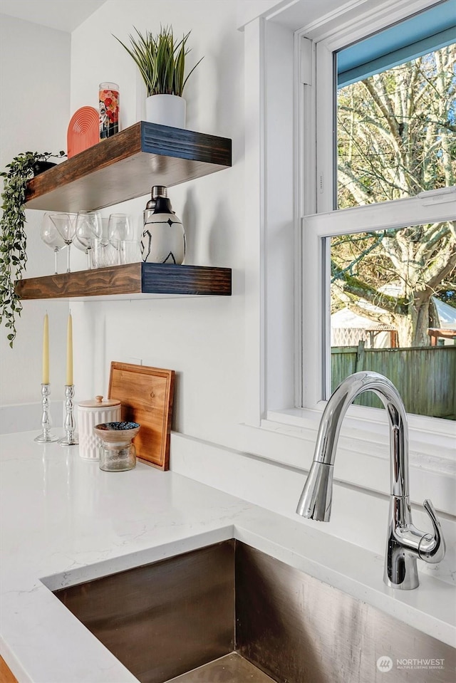 room details with light stone countertops and sink