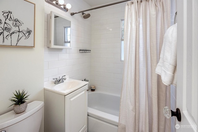 full bathroom featuring shower / tub combo, a healthy amount of sunlight, vanity, and toilet