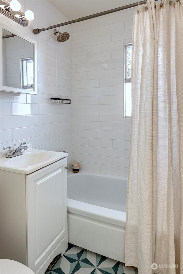 bathroom featuring shower / tub combo with curtain, vanity, and tile walls