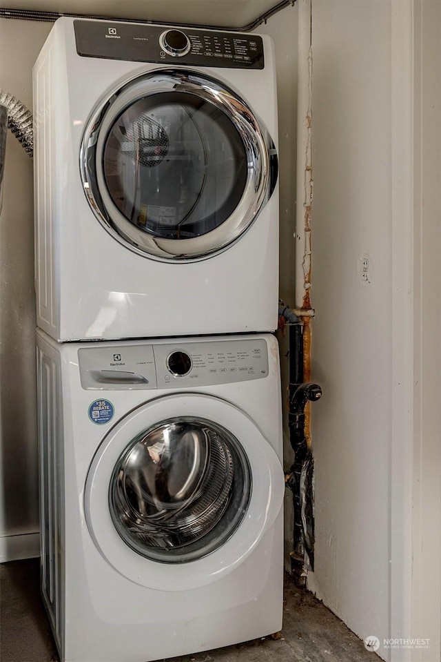 laundry area featuring stacked washing maching and dryer