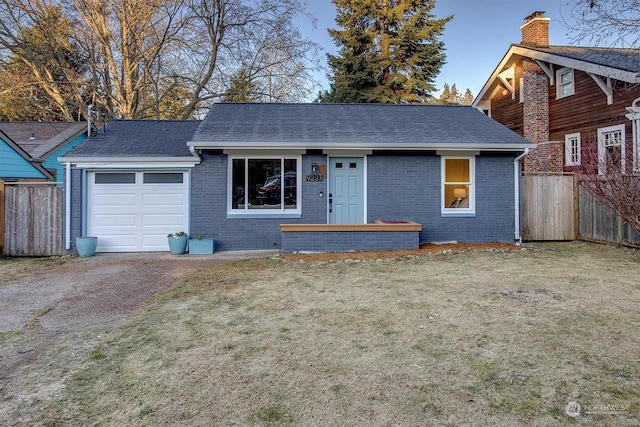 view of front of home featuring a garage and a front lawn