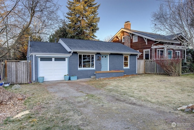 view of front of property featuring a garage and a front yard