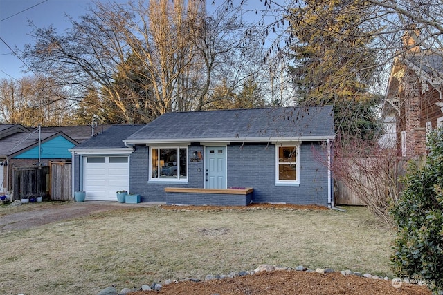 single story home with a garage and a front lawn